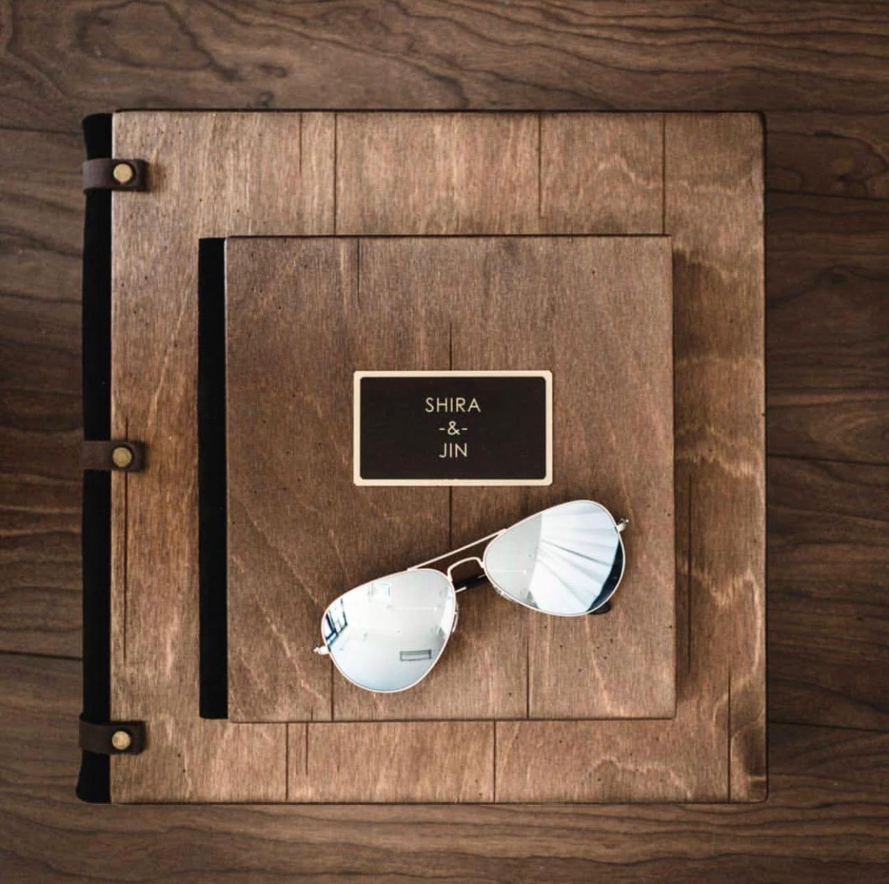 Two original wooden albums with leather straps, brass rivets and a personalised nameplate
